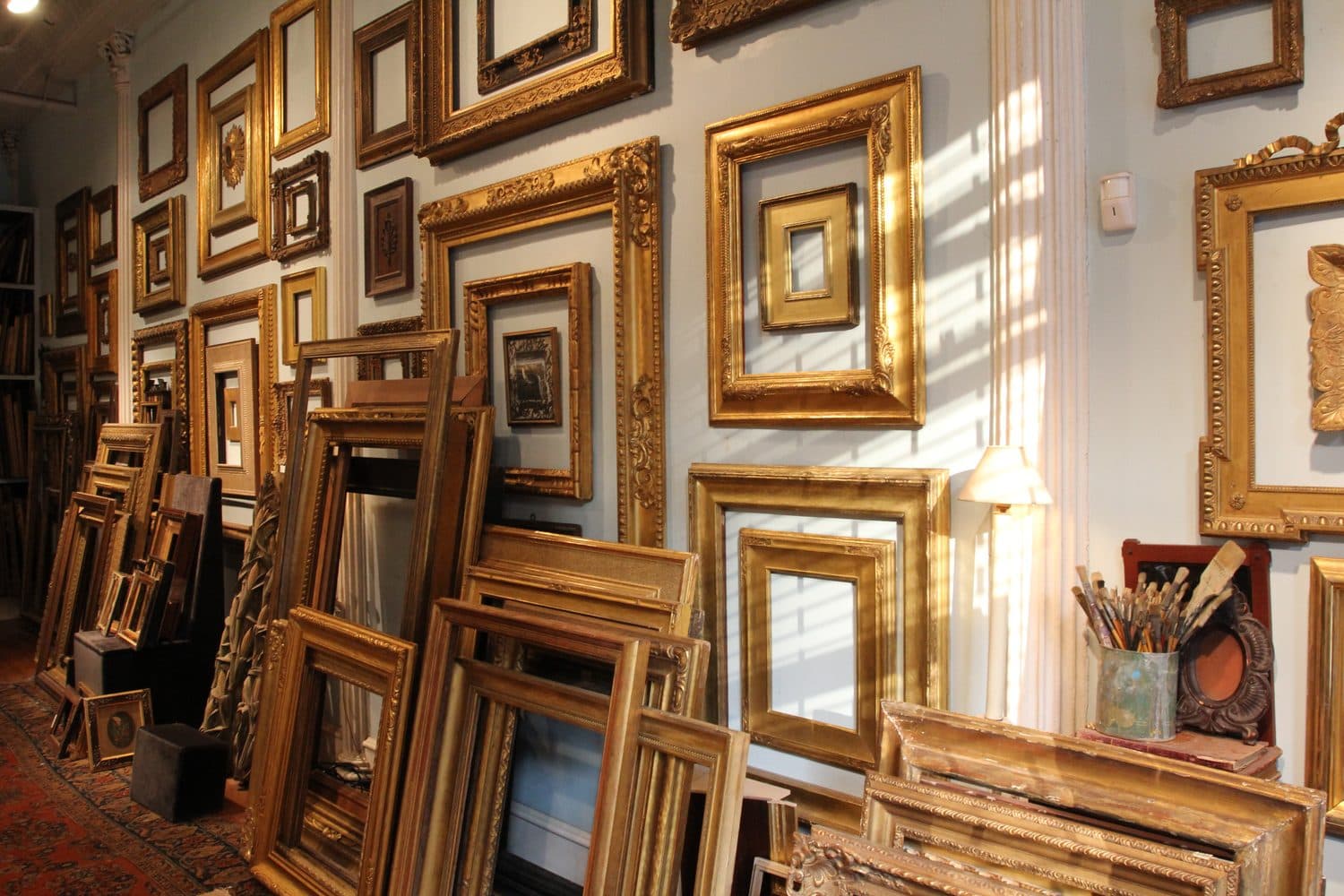 Framing shop interior with golden frames